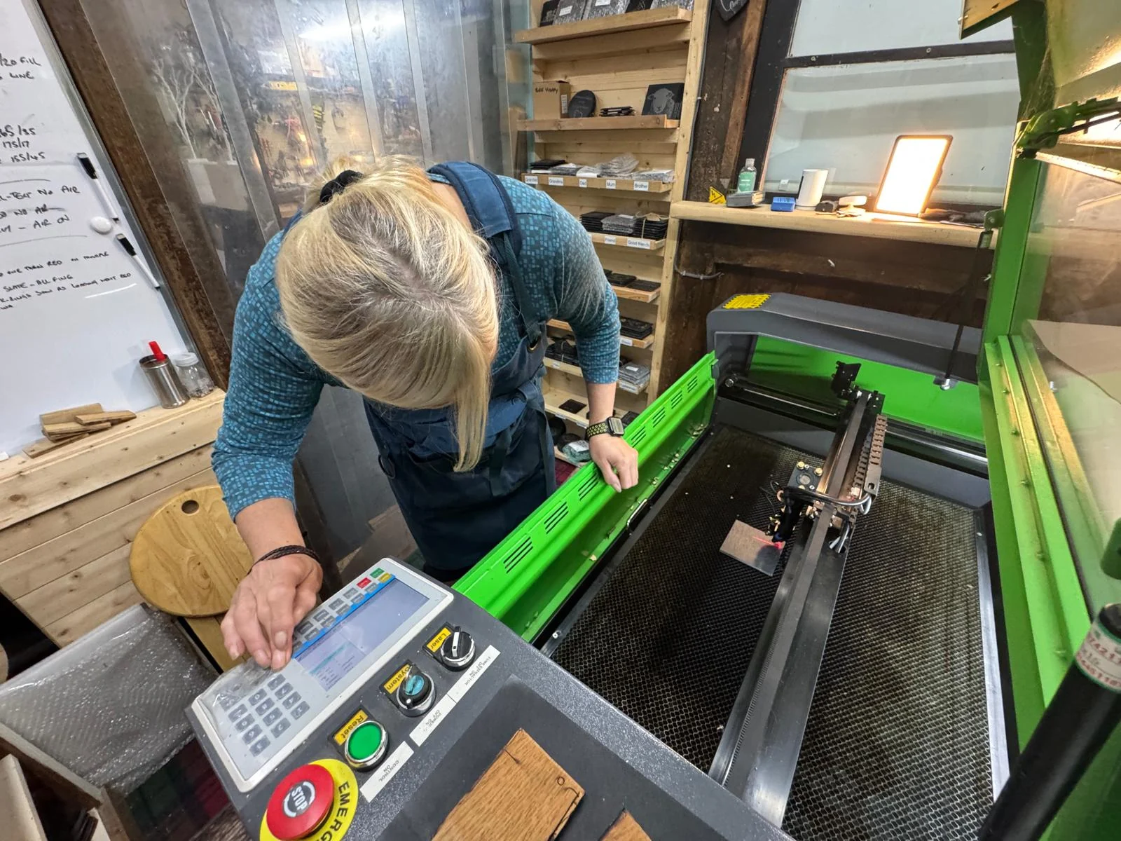 Christyne working at the laser engraving machine in her workshop